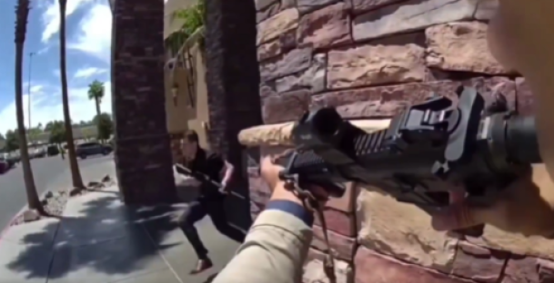 Person aiming a rifle at another person running away.