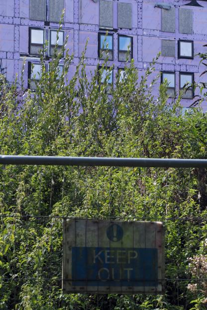 "Keep Out" sign in front of an abandoned student accommodation block.