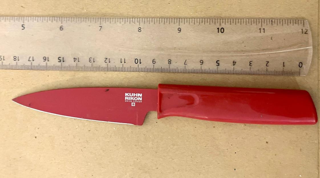 Red knife next to ruler.