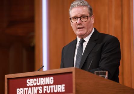 Keir Starmer giving a press conference on immigration.