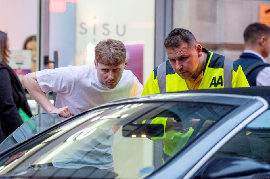 Jamie Borthwick with an AA first responder by his broken-down Mercedes.