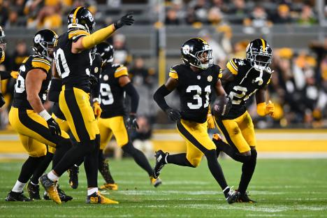 Pittsburgh Steelers player #31 running with the football after an interception.