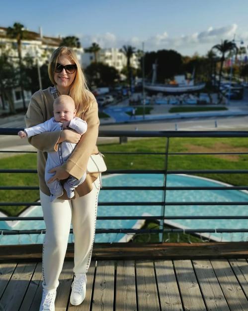 Anastasiia Chikina holding her son Oliver Pugh in Marbella, Spain.