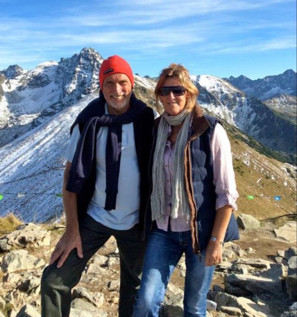 Michele Faiers and Michael Whitbread posing for a photo in the mountains.