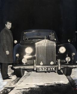 Black and white photo of Gangster Eddie Richardson with his Rolls-Royce.