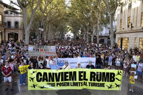 Protestors in Palma de Mallorca holding a banner that reads 