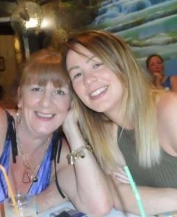 Photo of two women sitting together at a table.