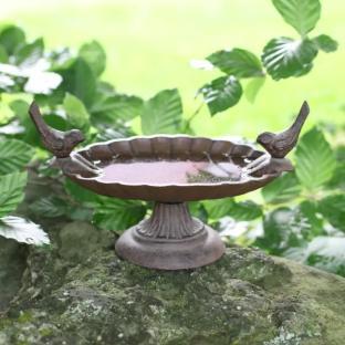 Cast iron bird bath with bird figurines.