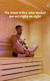 Man sitting cross-legged in a sauna.