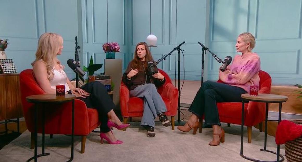 Three women sitting in red armchairs with microphones for a podcast recording.