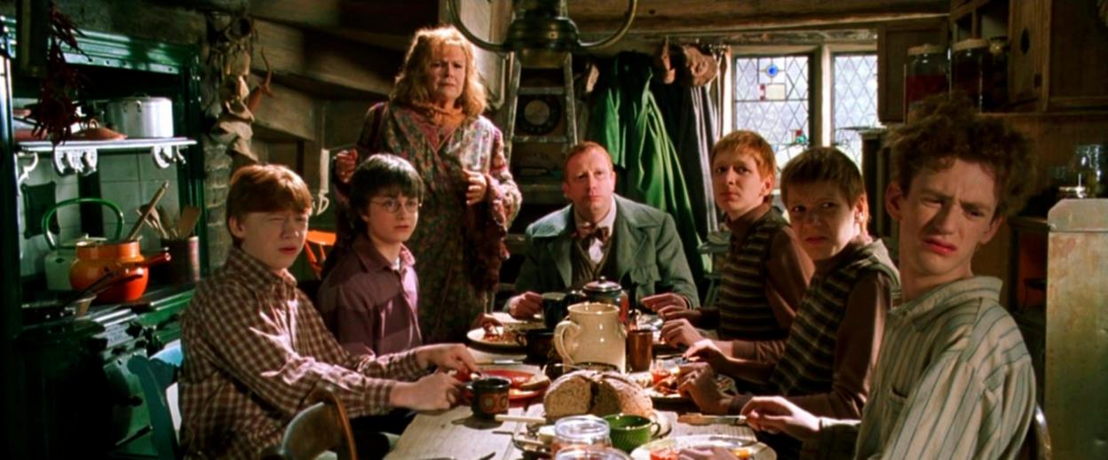 Scene from Harry Potter and the Chamber of Secrets: Harry and the Weasley family at breakfast.