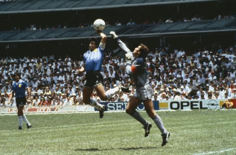 Diego Maradona scoring a goal with his hand against England in the 1986 World Cup.