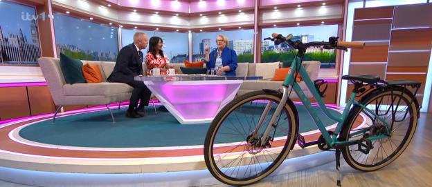 Screenshot of a teal bicycle on a television show set.