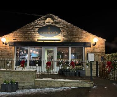 Norman's Neighbourhood Kitchen restaurant at night.