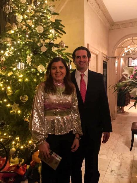 Marissa Laimos poses with an unnamed man in front of a Christmas tree.