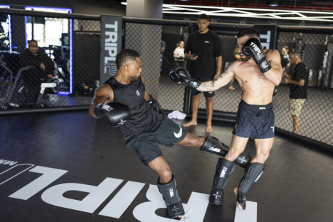 Two men sparring in a gym.