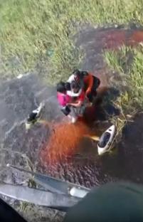 People being rescued from floodwaters.