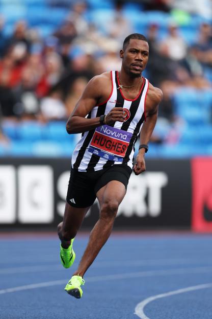 Zharnel Hughes running in a 200-meter race.
