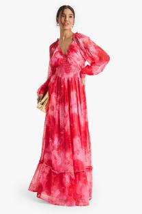 Woman in a long pink floral dress.