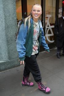 JoJo Siwa smiling in the rain in New York City.