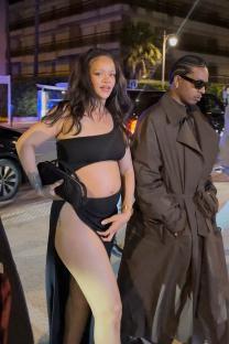 Rihanna and A$AP Rocky walking at night.