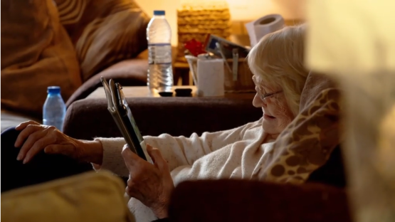 Elderly woman using a tablet.