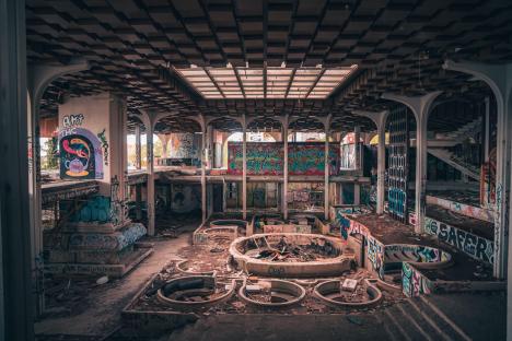 Sepia-toned photo of the graffiti-covered interior of the abandoned Haludovo Palace hotel.