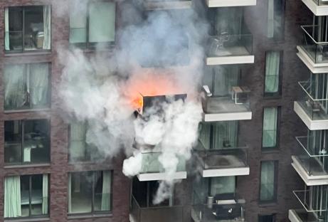 Apartment building fire with heavy smoke.