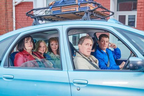Cast of Gavin & Stacey in a light blue car.