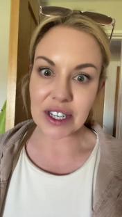 A woman looks mortified after realizing her outfit choice.