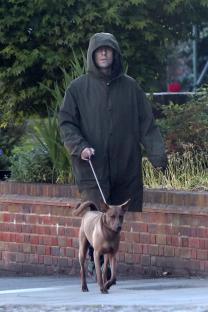 Liam Gallagher walking his dog.