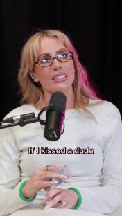 Olivia Attwood speaking into a microphone, discussing kissing.