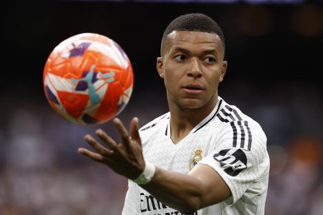 Kylian Mbappé, Real Madrid forward, controls a soccer ball.