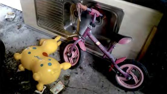Children's toys and bicycle found in a box factory.