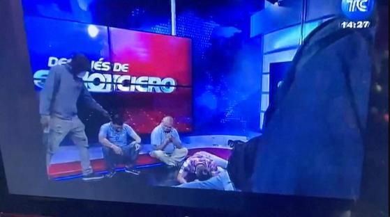 Screenshot of armed individuals taking over an Ecuadorian TV studio during a live broadcast.