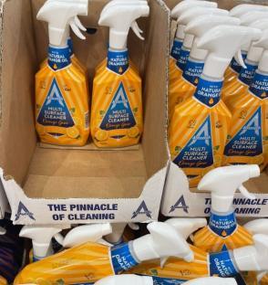 Many bottles of Astonish Multi Surface Cleaner in orange boxes.