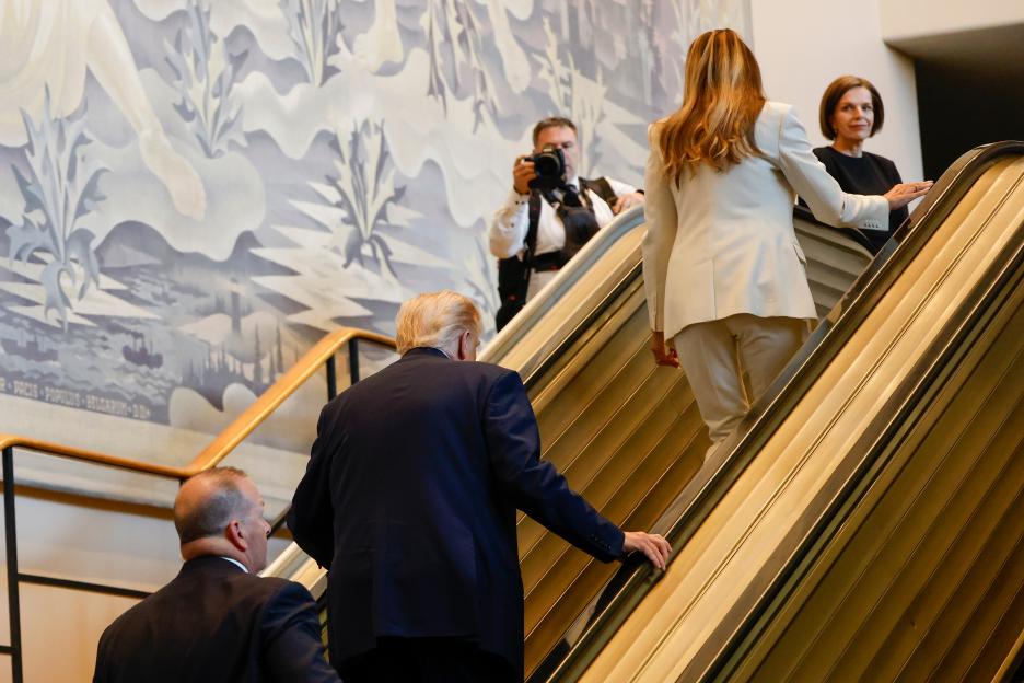 President Donald Trump and First Lady Melania Trump walking up an escalator after it stalled at U.N. headquarters.