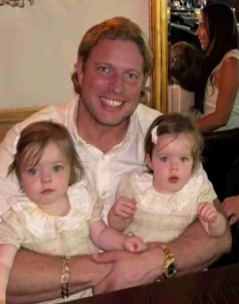 Tom Skinner, his wife, and children sitting at a restaurant table.
