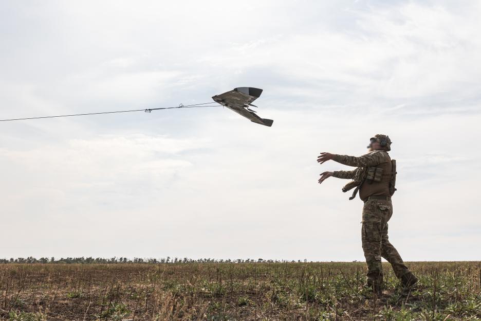 Ukrainian soldier launching a reconnaissance drone.