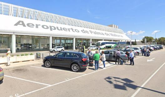 Palma de Mallorca Airport exterior with passengers and cars.