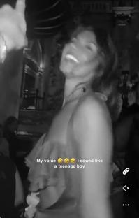 Black and white video of a woman laughing in a car, with text overlay saying