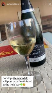 A glass of sparkling wine next to a bottle of Vinart Brut.