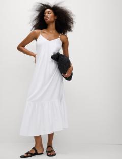 Model wearing a white linen-rich midi dress.