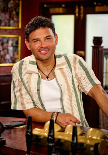 Man smiling at bar.