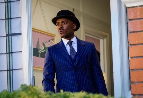Ncuti Gatwa as the Doctor in a pinstripe suit and bowler hat.