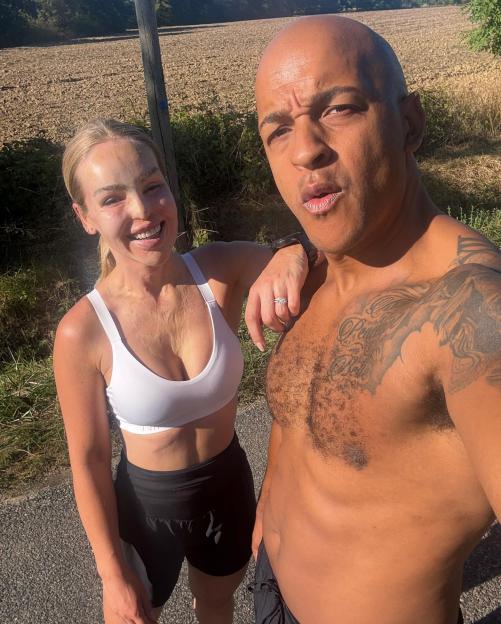 Katie Piper with her husband in workout clothes outside.