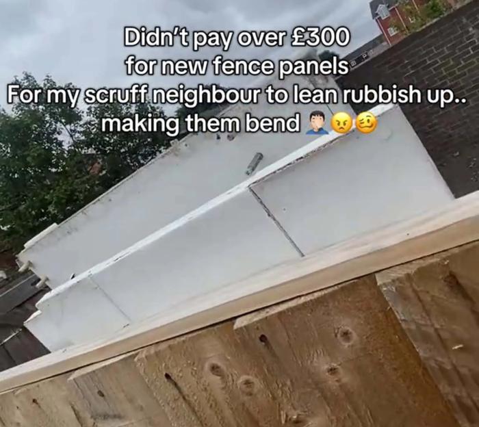 New fence panels damaged by neighbor's rubbish.