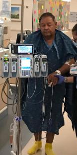Collage of two people in a hospital room; Romans 8:28 is written on the image.
