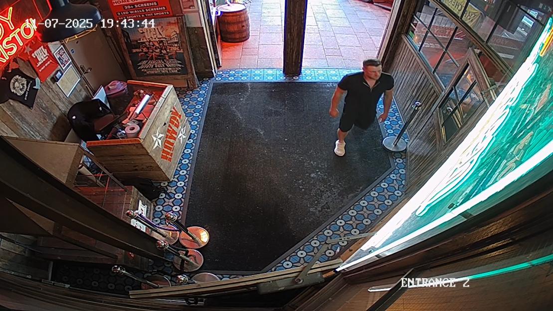 CCTV image of a man at a bar entrance.