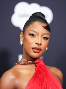 Portrait of Victoria Monét in a red dress.